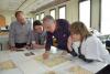 Left to right: Archives Division Director Dr. Haim Gertner, Zosia Tabaczynski, Wlodek Tabaczynski and Varda Gross, Director of the Restoration Laboratory at Yad Vashem  looking at restored pages from Wlodek's father's diary, written in the Warsaw ghetto